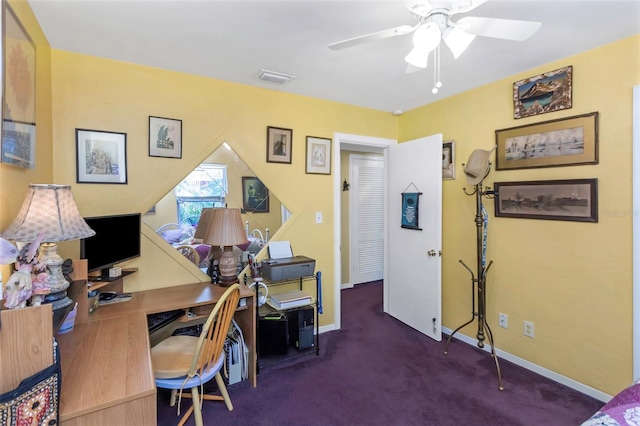 home office with ceiling fan and dark colored carpet