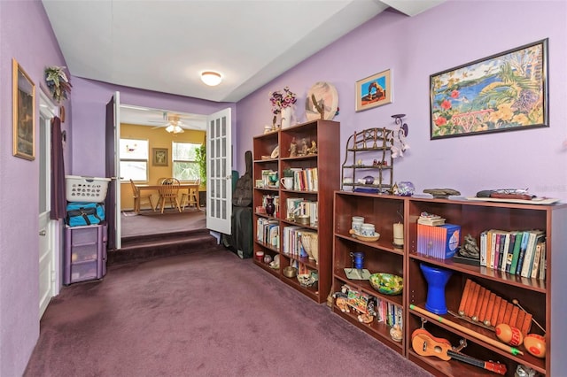 misc room with ceiling fan, dark carpet, and french doors