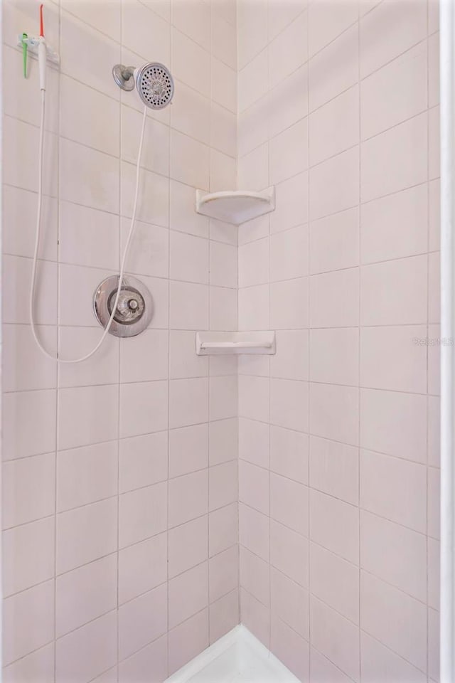 bathroom with tiled shower