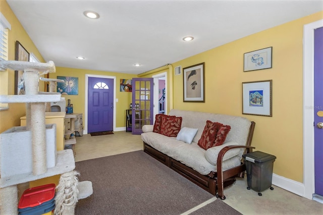 living area featuring recessed lighting and baseboards