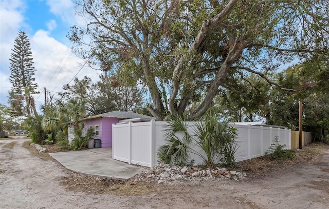 view of outbuilding with fence