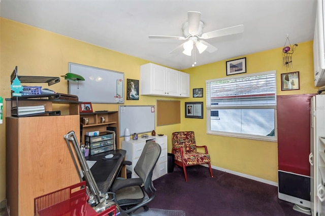 home office with baseboards, ceiling fan, and carpet floors