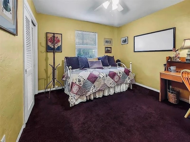 carpeted bedroom featuring a closet, a ceiling fan, and baseboards