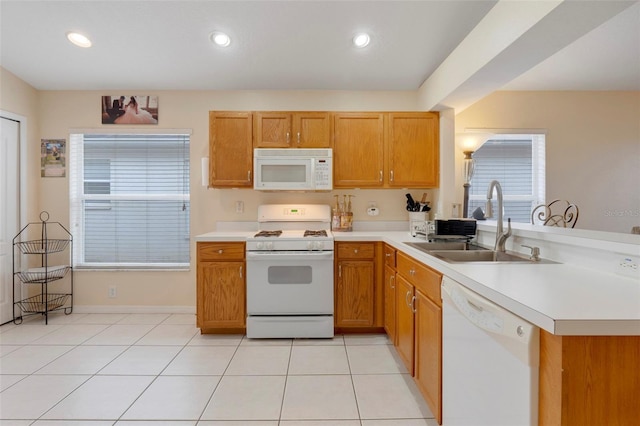 4605 Lisette Cir, Brooksville, FL 34604 - kitchen with white appliances, a sink, a peninsula, light countertops, and recessed lighting