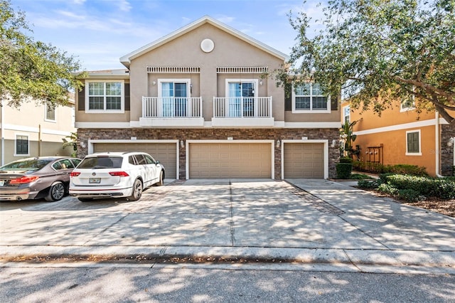 view of front of home with a balcony and a garage