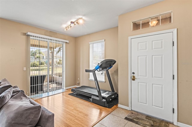 exercise room with light tile patterned floors