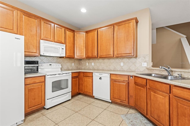 kitchen featuring light tile patterned flooring, sink, tasteful backsplash, and white appliances