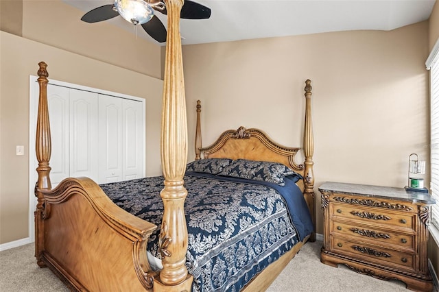 bedroom with ceiling fan, a closet, and light carpet