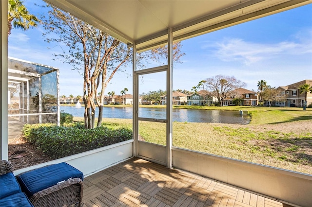 unfurnished sunroom with a water view