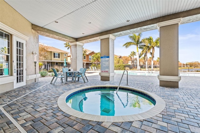 view of pool featuring a patio area and a community hot tub