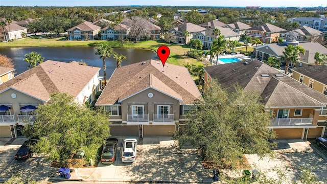 birds eye view of property with a water view