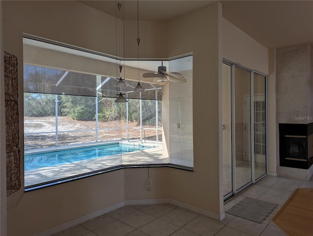 view of pool featuring ceiling fan and a multi sided fireplace