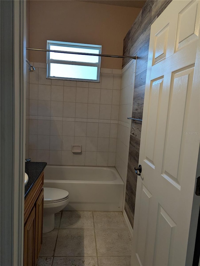 full bathroom with vanity, tiled shower / bath combo, and toilet