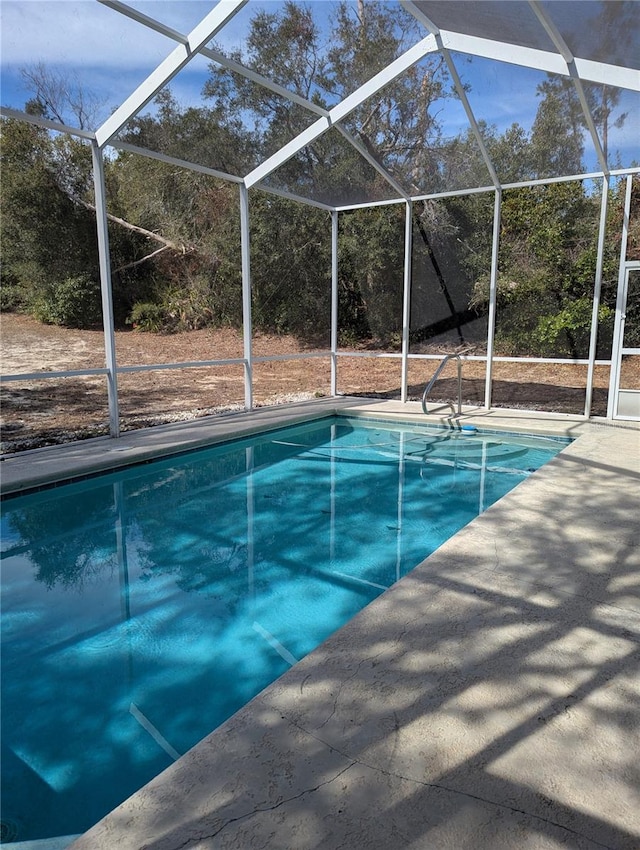 view of pool with a lanai and a patio