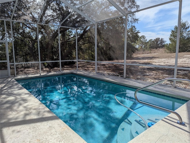 view of pool with glass enclosure