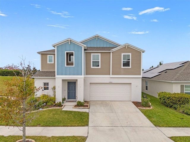 view of front of house with a front yard and a garage