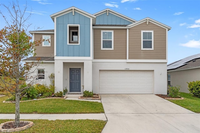 view of front of home with a front lawn and a garage