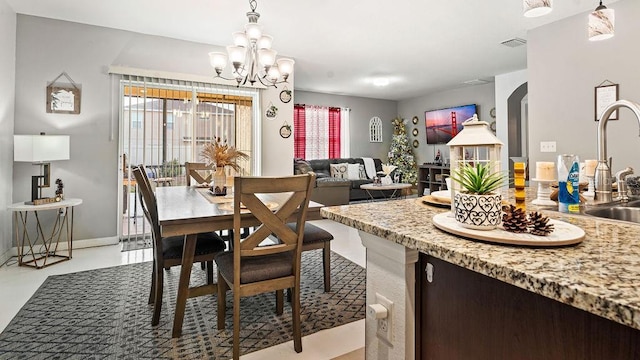 dining space with an inviting chandelier and sink