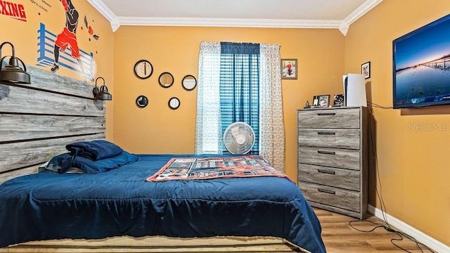 bedroom with ornamental molding and light wood-type flooring