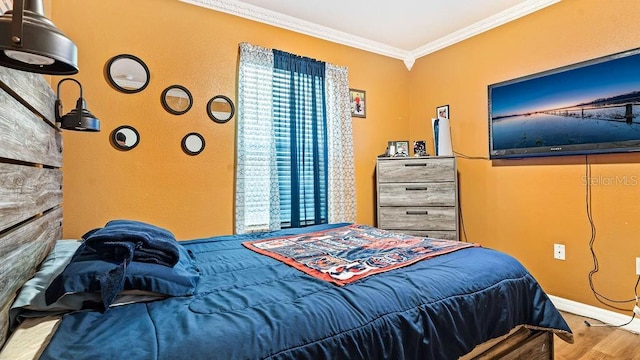 bedroom with crown molding and wood-type flooring