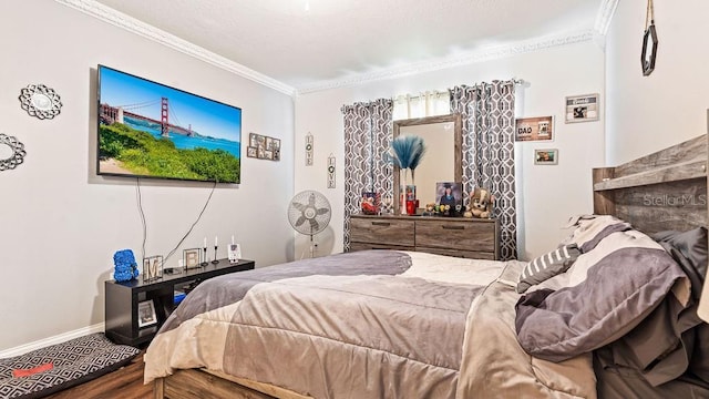 bedroom with ornamental molding and hardwood / wood-style floors