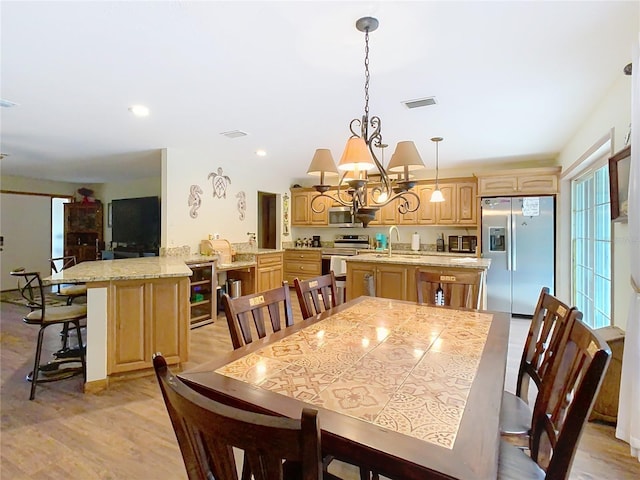 dining space featuring sink and light hardwood / wood-style flooring