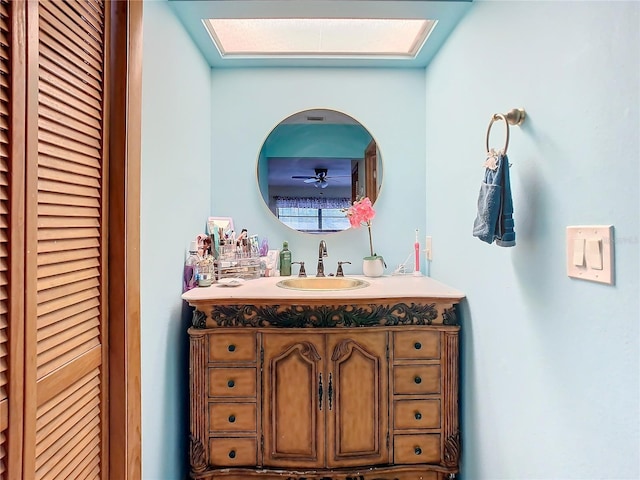 bathroom with ceiling fan and vanity