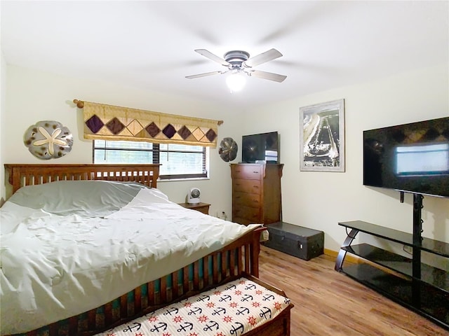 bedroom with ceiling fan and wood-type flooring