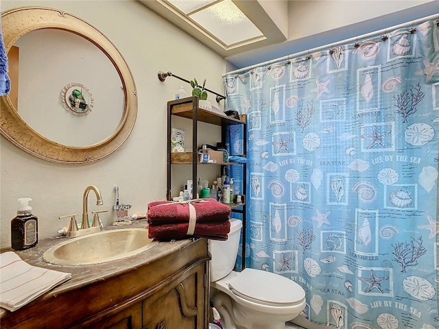 bathroom with toilet, vanity, and a shower with shower curtain