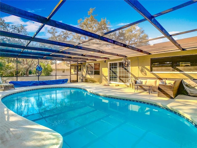 view of swimming pool featuring glass enclosure, an outdoor living space, and a patio