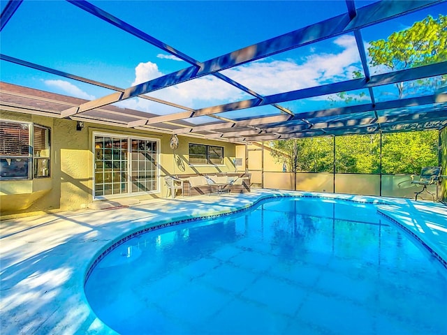 view of swimming pool with a lanai and a patio