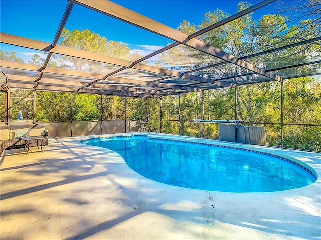 view of pool with a lanai and a patio