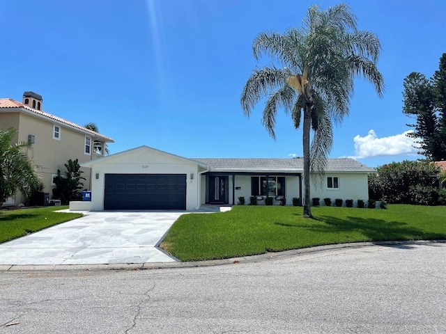 view of front of home featuring a front yard and a garage