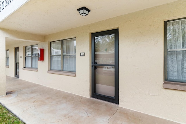 doorway to property with a patio area