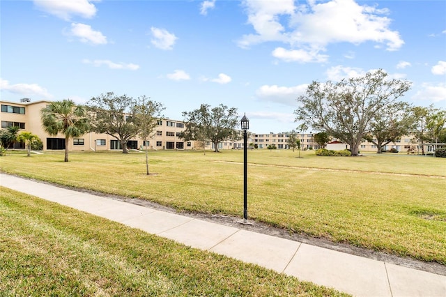 view of home's community with a lawn