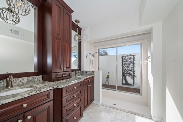 bathroom with vanity, a notable chandelier, and walk in shower