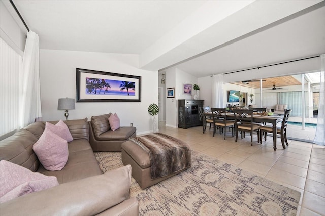 tiled living room featuring vaulted ceiling and ceiling fan