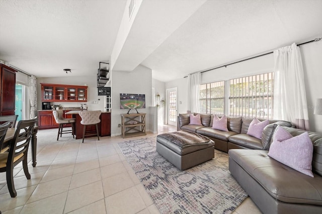 tiled living room featuring lofted ceiling