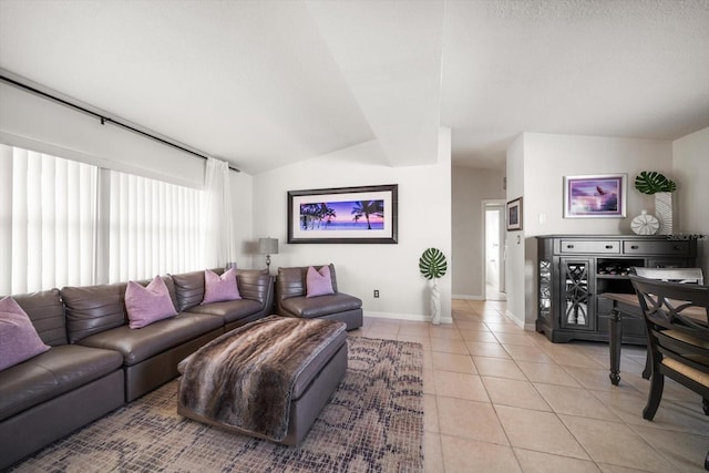 living room with light tile patterned flooring and vaulted ceiling