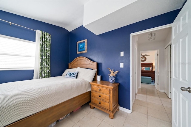 bedroom with vaulted ceiling and light tile patterned floors