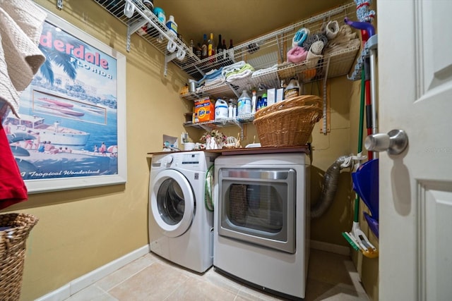 laundry room with light tile patterned flooring and washer and dryer