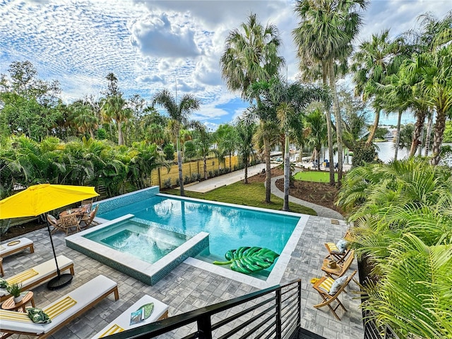 view of swimming pool with a pool with connected hot tub and a patio