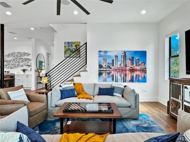 living room featuring visible vents, wood finished floors, recessed lighting, ceiling fan, and stairs