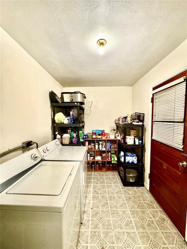 laundry area featuring washer and dryer and a textured ceiling