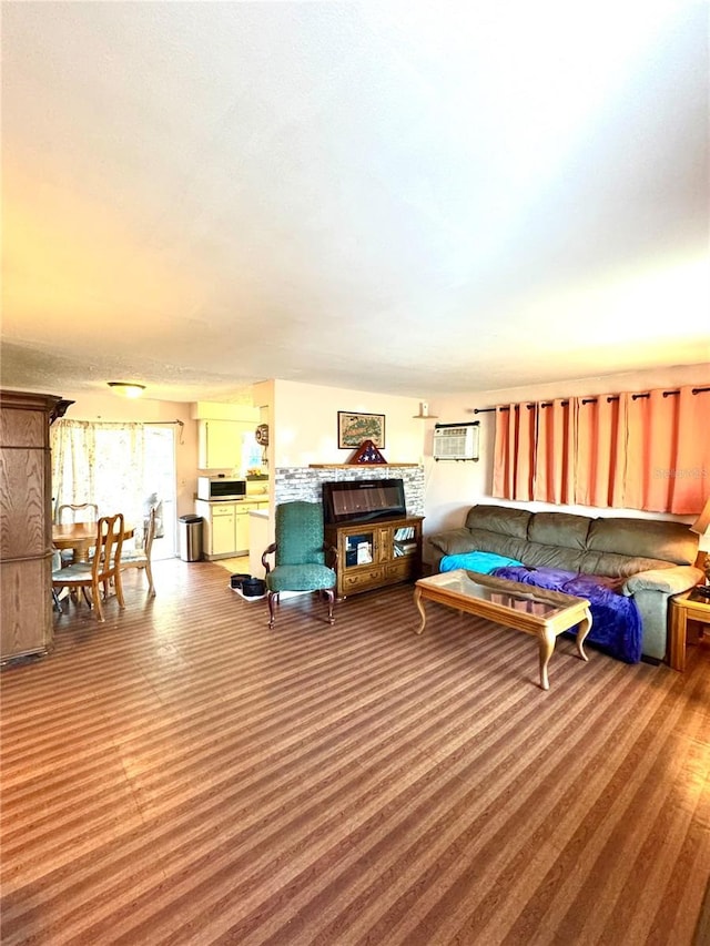 carpeted living room featuring a wall unit AC