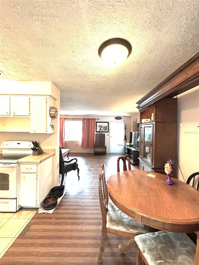 dining area with a textured ceiling and hardwood / wood-style flooring