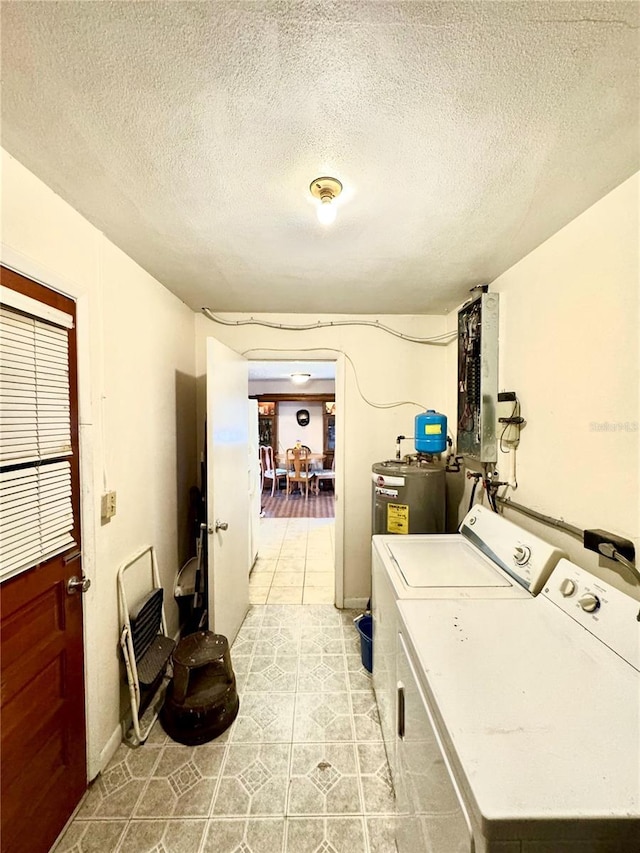 washroom featuring a textured ceiling, light tile patterned flooring, independent washer and dryer, and electric water heater