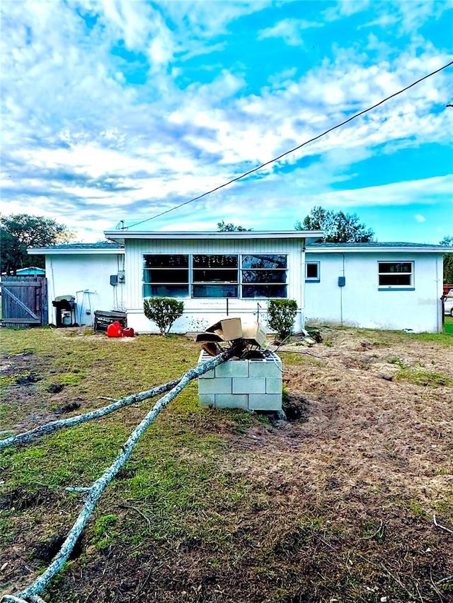 rear view of house with a yard