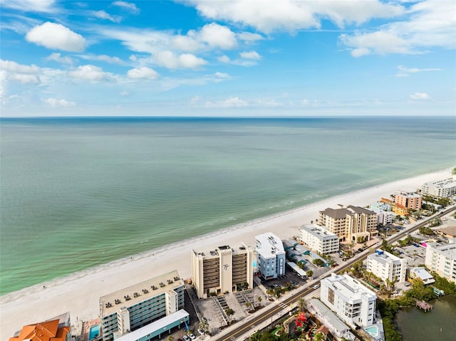 birds eye view of property featuring a beach view, a water view, and a city view