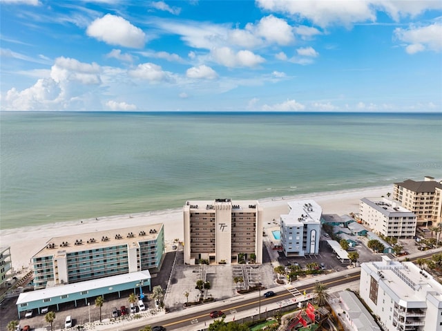 drone / aerial view with a city view, a beach view, and a water view